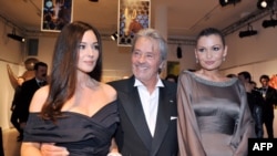 Lola Karimova-Tillyaeva (right) with French actor Alain Delon and Italian actress Monica Bellucci (left) pose before attending a gala dinner for the launch of the charity fund "Uzbekistan 2020" in Paris in 2009.