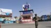 An Afghan soldier stands guard near an empty square in Kunduz city.