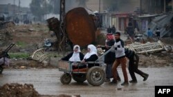 Civilians flee the city of Mosul on March 23 as Iraqi forces advance in their massive operation to retake Iraq's second city from Islamic State militants.