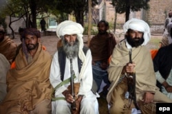 Militants from the banned Baloch Liberation Army organization wait to hand over their weapons during a surrender ceremony in Quetta.