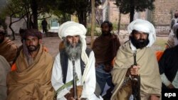 FILE: Purported members of the banned Baloch Liberation Army organization wait to hand over their weapons during a surrender ceremony in Quetta, capital of Balochistan Province in November 2015.