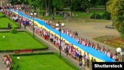 Під час відзначення Дня Державного Прапора України в Ужгороді. Учасники святкування несуть 100-метровий синьо-жовтий стяг, 23 серпня 2016 року