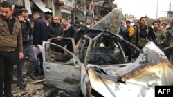 Syrians gather at the site of a car-bomb explosion in Syria's coastal city of Jableh on January 5.