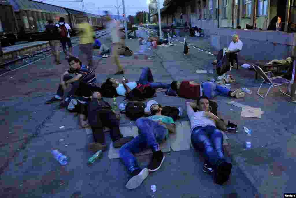 Migrants rest on a platform at Gevgelija railway station in Macedonia. (Reuters/Ognen Teofilovski)