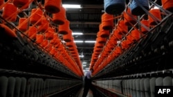 Kosovo -- A man works at a textile factory near the southern town of Dragash, 25Jan2013