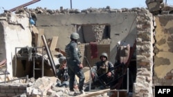Afghan policemen at the site of a suicide bombing attack on the police headquarters in the s eastern Gardez city.