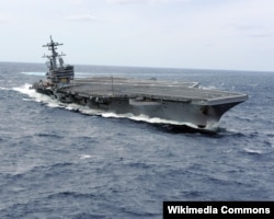 The USS George H.W. Bush aircraft carrier is reportedly transporting thousands more US mililtary personnel to the Persian Gulf. (file photo)