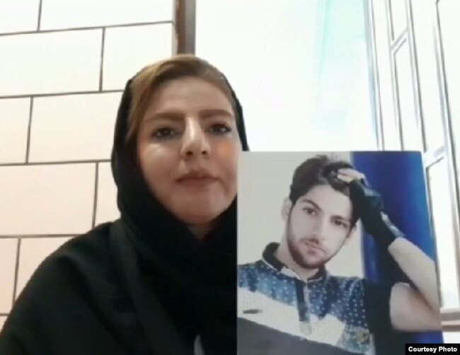 Farzaneh Ansarifar with a picture of her dead brother, Farzad.