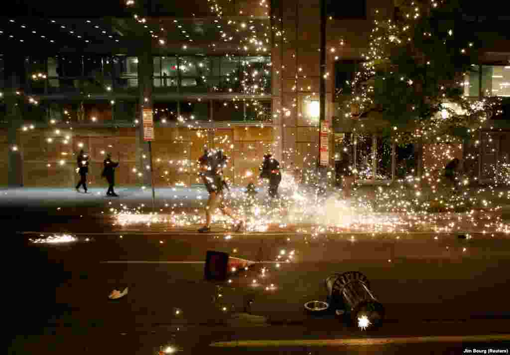 U.S. -- People run as police disperse demonstrators during a protest amid nationwide unrest following the death in Minneapolis police custody of George Floyd, in Washington