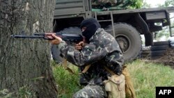 A pro-Russian militant takes aim at a checkpoint in the eastern city of Slovyansk on June 3.