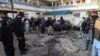 Pakistani security personnel gather evidence at the blast site of a deadly suicide attack by the TTP extremist group in the northern city of Mardan that killed at least 21 people on December 29. 