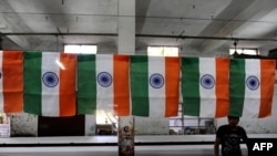 India -- A worker folds an Indian National Flag at Roopalee Textiles in Ahmedabad, 19Jan2010