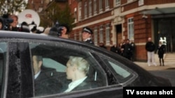 Julian Assange arrives at a London prison on December 7