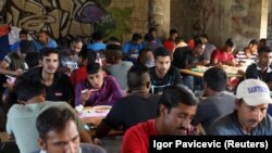 Migrants eat in a dorm in Bihac, Bosnia, on August 20.
