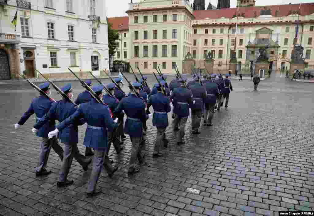 The ceremonial guard of Prague Castle marches toward the entrance after the castle&rsquo;s gates opened on the morning of May 25 after being shut since March.