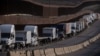 Trucks line up next to the border before crossing into the United States near Tijuana, Mexico.