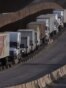 Trucks line up next to the border before crossing into the United States near Tijuana, Mexico.