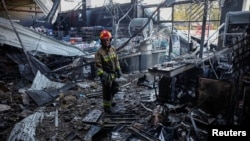 A firefighter examines the ruins of a supermarket in the Ukrainian city of Chernihiv after a Russian drone attack.