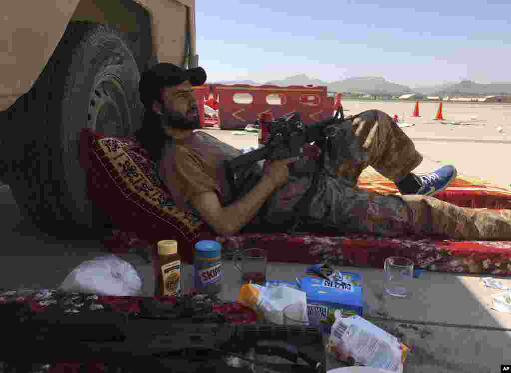 A Taliban fighter rests inside the Hamid Karzai International Airport in Kabul on September 5.
