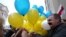 Belarusian opposition protesters share blue and yellow balloons to show their solidarity with Ukraine, during a rally marking the unofficial Freedom Day in Minsk on March 25. 