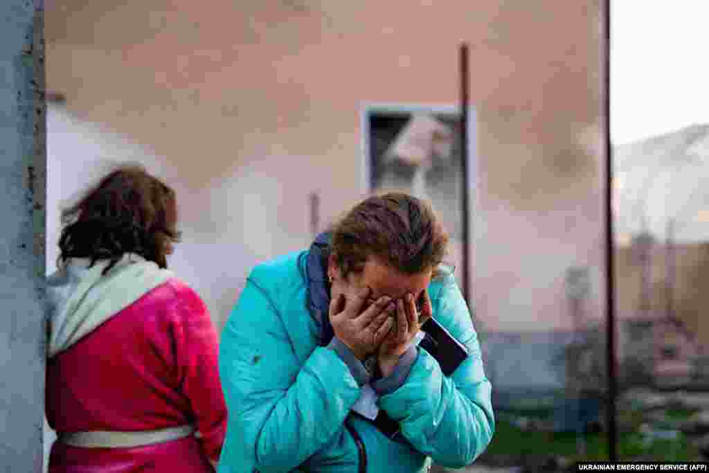 A woman reacts in the courtyard of a damaged building following a missile strike at an undisclosed location in the Odesa region.&nbsp;