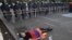 Armenia - A protester lies on the ground near riot police deployed on Marshal Bagramian Avenue, Yerevan, 26Jun2015.
