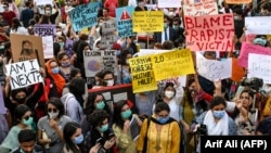 Human right activists protest in Lahore on September 12 against the alleged gang rape of a woman in front of her children.