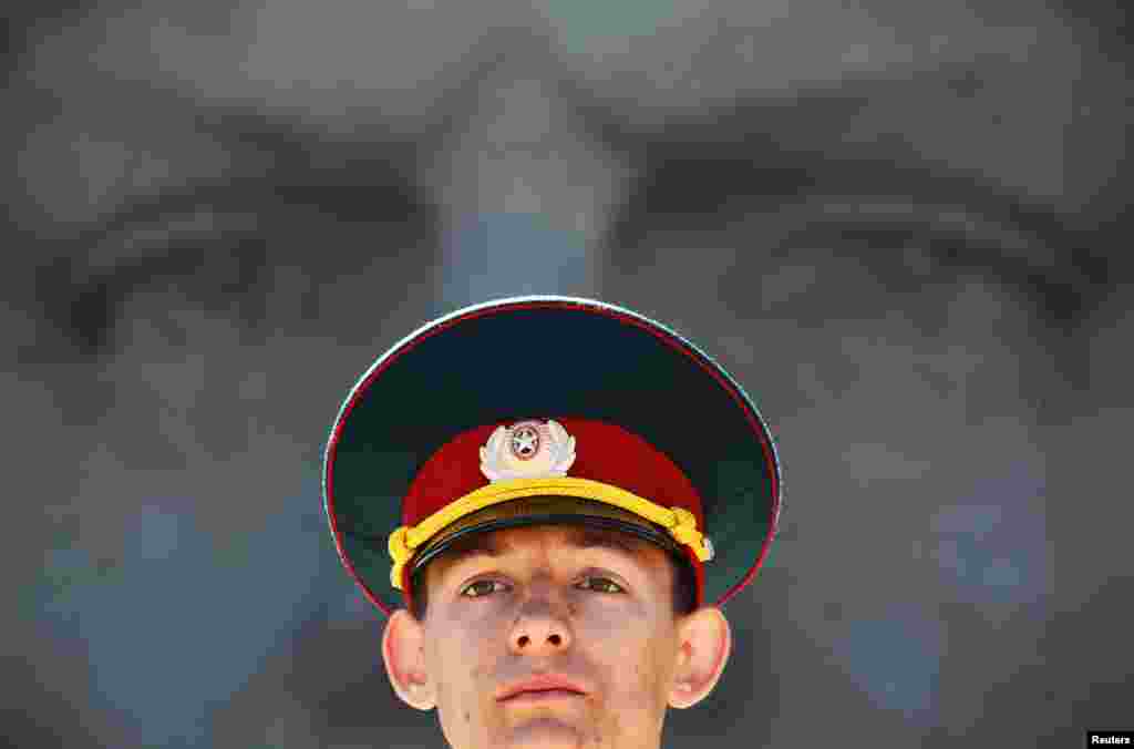 An honor guard stands by the Eternal Glory WWII monument during an inauguration ceremony for newly adopted members of the Young Army military patriotic movement in the southern Russian city of Stavropol. (Reuters/Eduard Korniyenko)