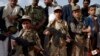 Yemeni children carrying weapons take part in a gathering organized by Shiite Huthi rebels to mobilize more fighters to battlefronts to fight pro-government forces, in the capital Sanaa, June 18, 2017