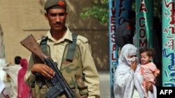 A Pakistani soldier stands guard near a market in Mardan (file photo)