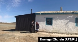 Chernysheva stands with her son, Vladimir, outside their house on the outskirts of Mugalzhar. Around 2,000 people live in the village.