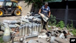 Ілюстраційне фото: фермер збирає фрагменти російської ракети, знайдені на його полі в Дніпропетровській області, 4 липня 2022 року