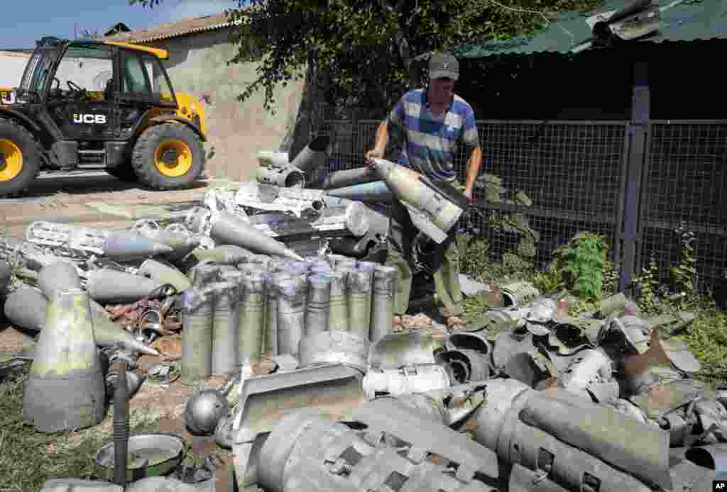 A farmer displays fragments of Russian rockets that he found on his field, 10 kilometers from the front line in the Dnipropetrovsk region, on July 4.