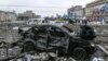 UKRAINE – A damaged car sits at the central square following shelling of the City Hall building in Kharkiv, March 1, 2022