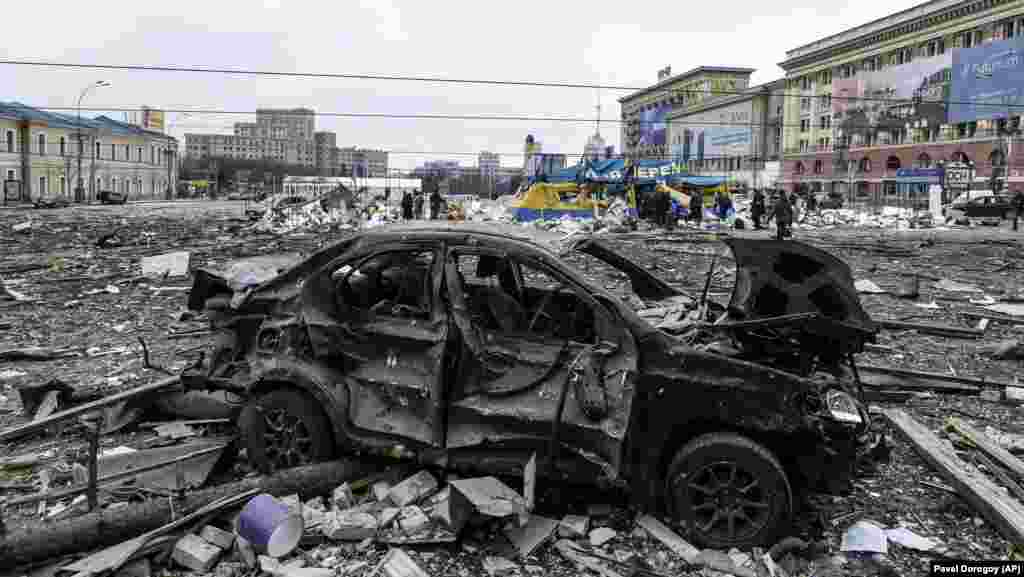 A damaged car sits on the central square of Kharkiv, Ukraine, on March 1 following the shelling of the City Hall building by Russian forces.&nbsp;