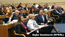 The Serbian member of the Presidency of Bosnia-Herzegovina, Milorad Dodik (center, turned), attends the National Assembly of Republika Srpska session on November 11.