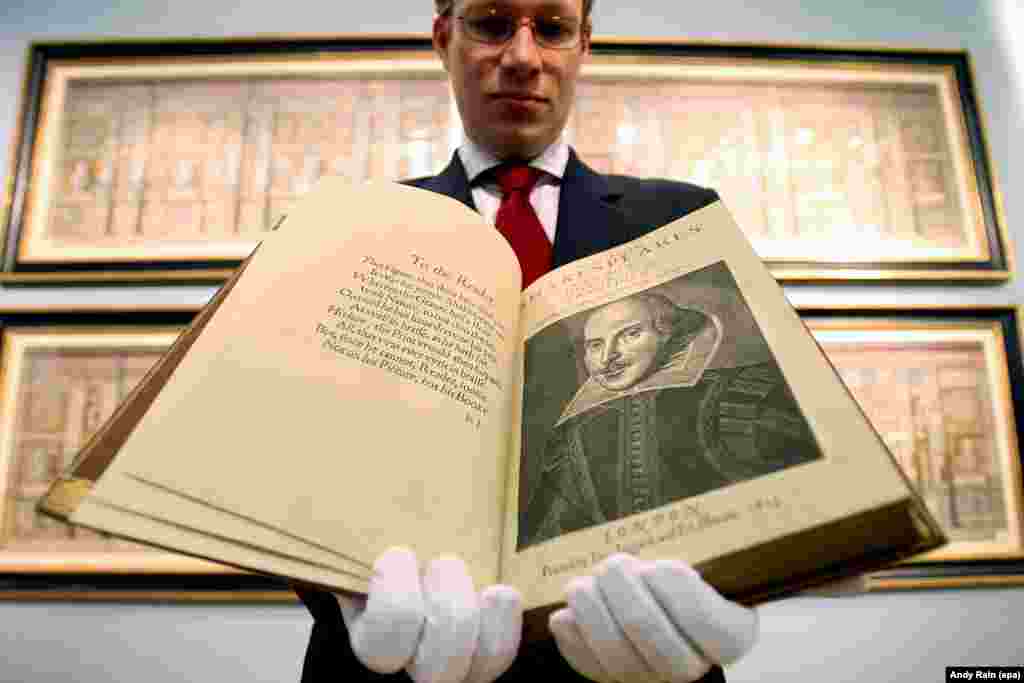 An employee of Christie&#39;s Auction House in London holds the First Folio, the first published collection of Shakespeare&#39;s plays. It is considered one of the most important books in English literature.