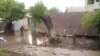 Residents examine flood damage in the village of Abdraimov in the Jalal-Abad region on May 12.