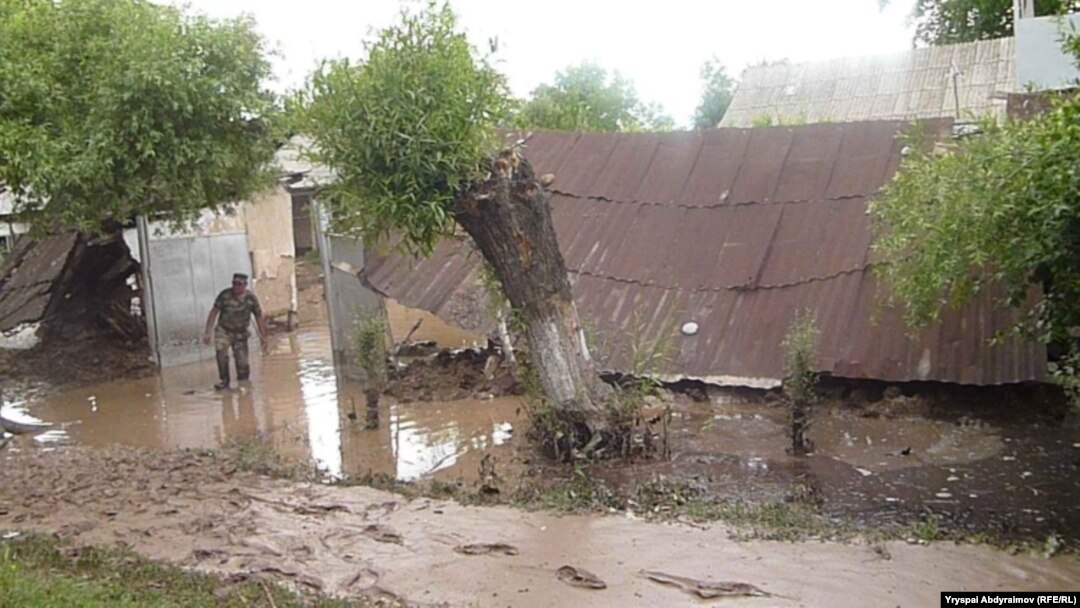 Residents examine flood damage in the village of Abdraimov in the Jalal-Abad region on May 12.