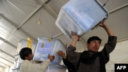 Afghan election workers move ballot boxes to the Independent Election Commission warehouse in Kabul on September 20.