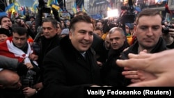 Former Georgian President Mikheil Saakashvili greets pro-European integration protesters in Independence Square in Kyiv on December 7. Ukraine's opposition accused President Viktor Yanukovich on Saturday of betraying national interests at