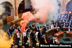 Smoke bombs were set off in parliament in protest at the passing of the amendment on March 18.