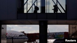 People walk along a corridor at Sheremetyevo airport in Moscow.