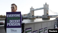 A picketer stands outside City Hall in central London.