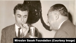 Miroslav Sasek (left) breaks the ice with a little humor before an interview for Radio Free Europe. January 1961.