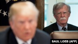 US President Donald Trump speaks alongside National Security Adviser John Bolton (R) during a Cabinet Meeting in the Cabinet Room of the White House in Washington, DC, May 9, 2018