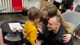 Released RFE/RL Belarusian service journalist Andrei Kuznechyk meets his family in Vilnius