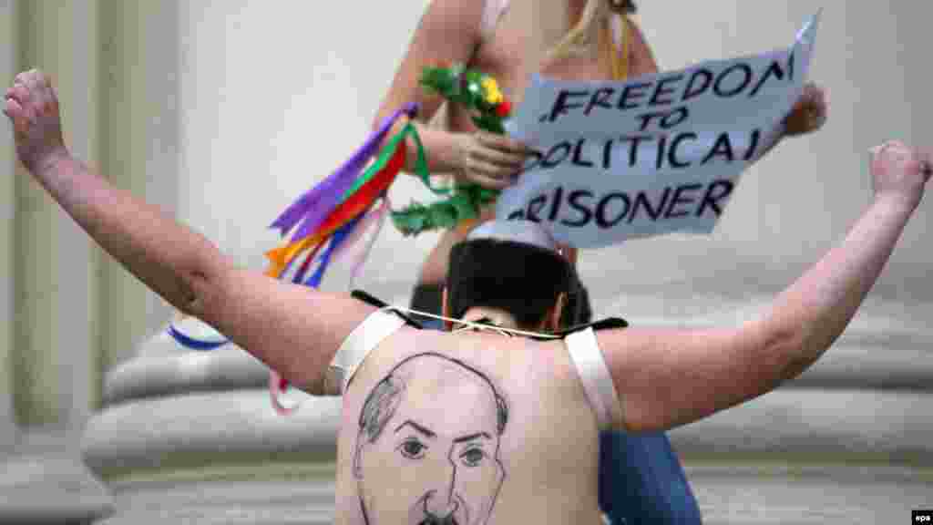 A half-naked activist of Ukrainian feminist group Femen shows her back, where Belarusian President Alyaksandr Lukashenka is depicted, in front of the KGB headquarters building in Minsk. (epa/Tatyana Zenkovich)