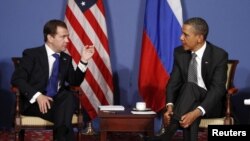 France -- US President Barack Obama (R) and his Russian counterpart Dmitry Medvedev speak during the G8 Summit in Deauville, 26May2011