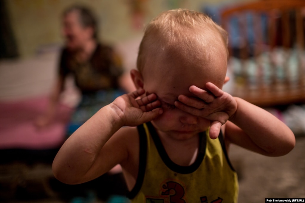 Маленький хлопчик налякано плаче від обстрілів, переховуючись у бомбосховищі в Петровському районі Донецька у серпні 2015 року. На той момент в укритті постійно проживало близько 40 місцевих жителів, зокрема 19 дітей.
